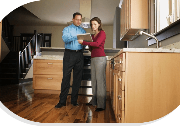 A man and woman standing in front of a kitchen.